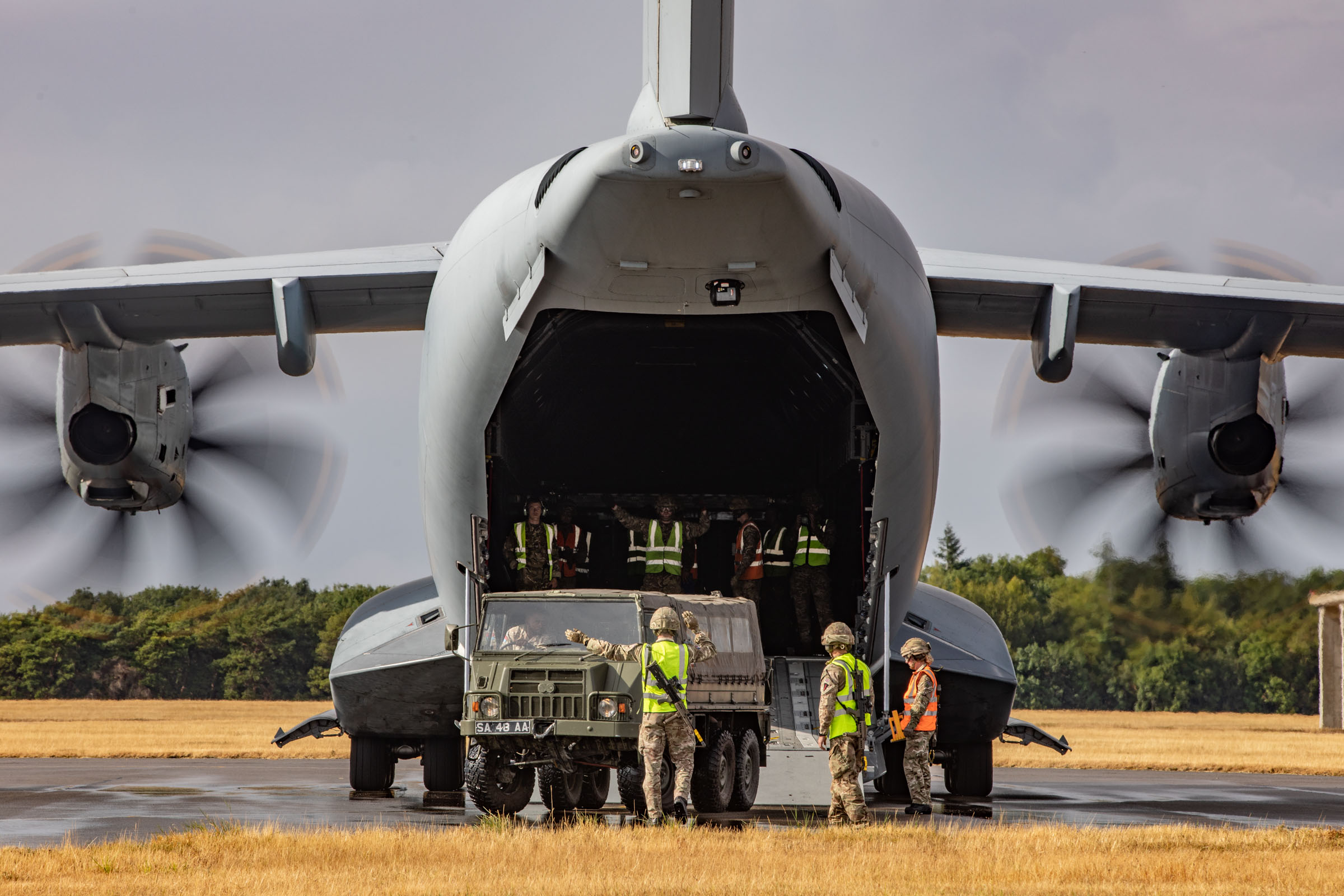 A Pinzgauer vehicle is loaded onto an A400M aircraft by 1AMW